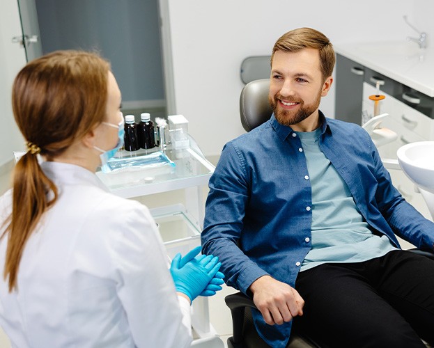 a man speaking with his dentist about dental crowns