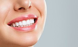 a patient with a healthy smile and dental crown