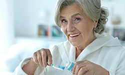 Patient in Casper with dentures eating healthy food