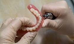 Lab technician filling dentures