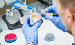 Lab technician carving dentures