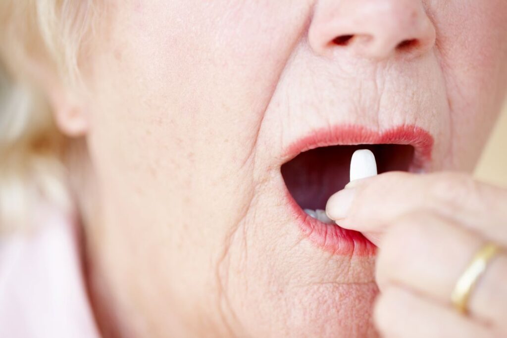 A woman holding a knocked-out tooth